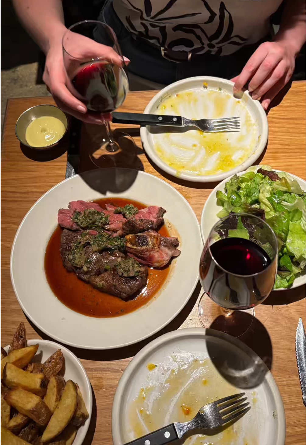 Serious wine and butter-drenched plates — video still by Milly Gurton